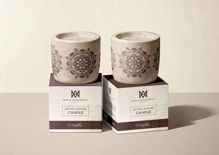 Scented candles in patterned boxes