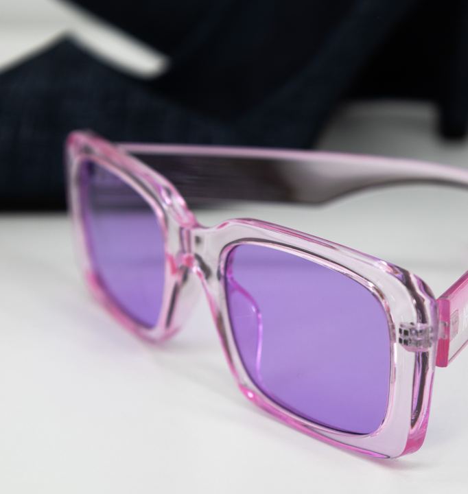 Translucent pink sunglasses with violet lenses