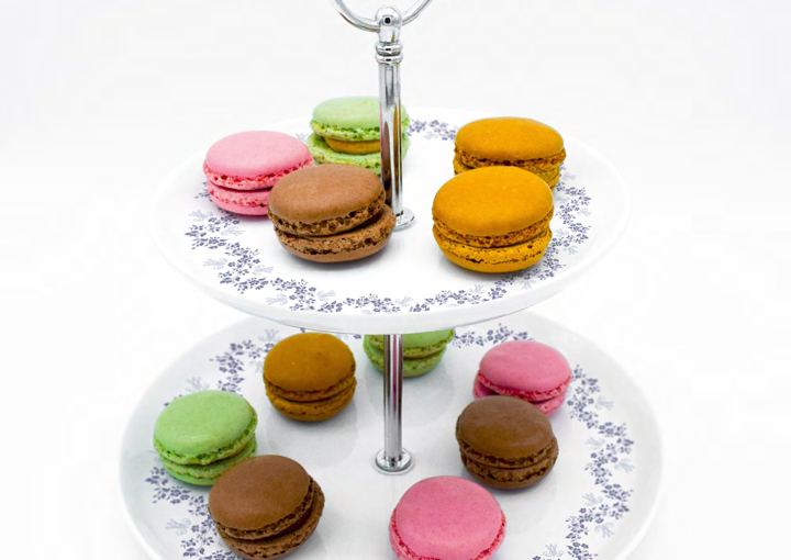 Colourful macarons on a patterned porcelain stand